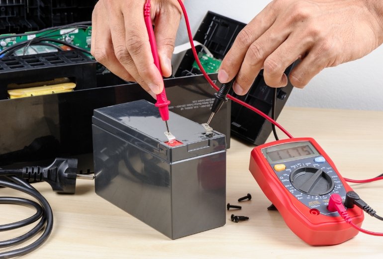 Technician repairing industrial online UPS system
